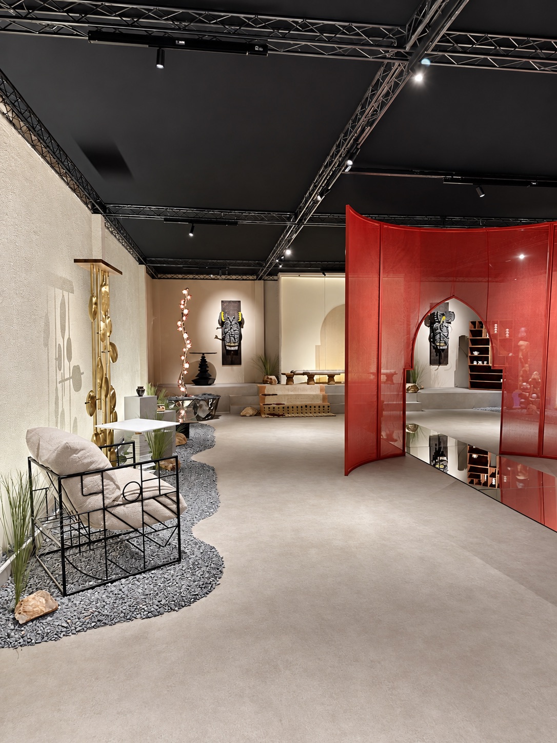 Delhi Art Fair exhibition interior with textured walls, sculptures and a red architectural screen